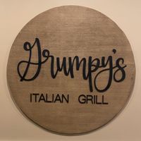 A wooden sign that says grumpys italian grill.