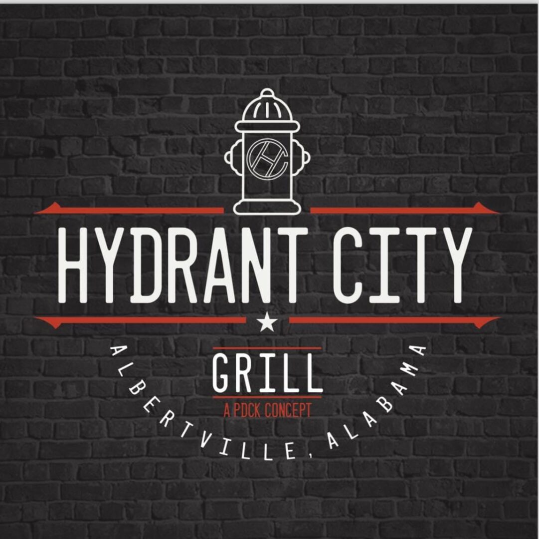 A black brick wall with the words " hydrant city grill ".