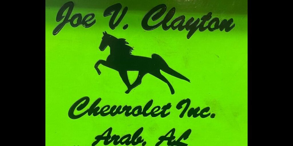 A neon sign with the name of joe v. Clayton chevrolet inc.